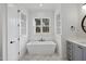 Modern bathroom featuring a soaking tub, marble floors, and modern fixtures at 2809 Theresa Eileen Way, Raleigh, NC 27603