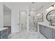 Bright bathroom featuring a glass shower, vanity with storage, and marble floors at 2809 Theresa Eileen Way, Raleigh, NC 27603
