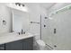 Modern bathroom with glass enclosed shower, gray vanity, and white tiled walls at 2809 Theresa Eileen Way, Raleigh, NC 27603