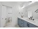 Light-filled bathroom featuring double vanities, modern fixtures, and tile flooring at 2809 Theresa Eileen Way, Raleigh, NC 27603