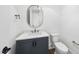 Elegant powder room features a gray vanity, marble countertop, and brushed gold fixtures at 2809 Theresa Eileen Way, Raleigh, NC 27603