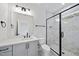 Beautiful bathroom featuring marble tile, a large mirror and sleek black hardware at 2809 Theresa Eileen Way, Raleigh, NC 27603