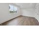 This well-lit bedroom features wood floors, large windows and a walk-in closet at 2809 Theresa Eileen Way, Raleigh, NC 27603