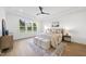 Bright bedroom featuring tray ceilings, wood floors, large windows and stylish decor, creating a cozy and elegant space at 2809 Theresa Eileen Way, Raleigh, NC 27603