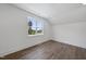 Bright bedroom featuring wood flooring, white trim, and a window overlooking the neighborhood at 2809 Theresa Eileen Way, Raleigh, NC 27603