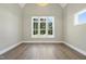 Bright bedroom with hardwood floors, modern light fixture and three large windows at 2809 Theresa Eileen Way, Raleigh, NC 27603