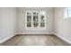 Bright bedroom features hardwood floors and a large window bringing in natural light at 2809 Theresa Eileen Way, Raleigh, NC 27603