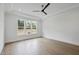 Bright bedroom features hardwood floors, a tray ceiling, and a stylish ceiling fan at 2809 Theresa Eileen Way, Raleigh, NC 27603