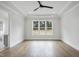 Bright bedroom features hardwood floors and a large window bringing in natural light at 2809 Theresa Eileen Way, Raleigh, NC 27603