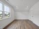 Bright bedroom with beautiful wood floors, a large window and a modern closet at 2809 Theresa Eileen Way, Raleigh, NC 27603