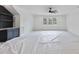 Open bonus room showcasing a ceiling fan, large windows, and built-in bar at 2809 Theresa Eileen Way, Raleigh, NC 27603