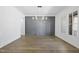 Bright dining room featuring elegant hardwood floors, a decorative gray wall, and a gold chandelier at 2809 Theresa Eileen Way, Raleigh, NC 27603