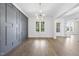 Bright dining room featuring elegant hardwood floors, a decorative gray wall, and large windows with natural light at 2809 Theresa Eileen Way, Raleigh, NC 27603