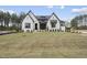 A newly built two-story home featuring a white brick facade and a freshly laid lawn at 2809 Theresa Eileen Way, Raleigh, NC 27603