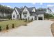 View of a newly constructed home with a white brick exterior, an attached garage, and a concrete driveway at 2809 Theresa Eileen Way, Raleigh, NC 27603