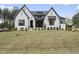 A stunning, newly built two-story home featuring a white brick facade and a freshly laid lawn at 2809 Theresa Eileen Way, Raleigh, NC 27603