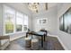 Bright home office with large windows, vaulted ceilings and a modern desk setup with ottomans, creating an inspiring workspace at 2809 Theresa Eileen Way, Raleigh, NC 27603