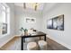 Bright home office with large windows, vaulted ceilings and a modern desk setup with ottomans, creating an inspiring workspace at 2809 Theresa Eileen Way, Raleigh, NC 27603