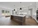 A modern kitchen with a center island, white cabinets, pendant lights and hardwood floors at 2809 Theresa Eileen Way, Raleigh, NC 27603
