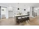 Open-concept kitchen with stainless steel appliances, a large island, and barstool seating at 2809 Theresa Eileen Way, Raleigh, NC 27603