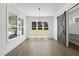 Bright Living Room featuring hardwood floors, large windows and a gray barn door at 2809 Theresa Eileen Way, Raleigh, NC 27603