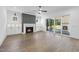 Bright living room featuring a fireplace, built-in cabinets, and large glass doors to outdoor patio at 2809 Theresa Eileen Way, Raleigh, NC 27603