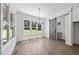 Bright Living Room featuring hardwood floors, large windows and a gray barn door at 2809 Theresa Eileen Way, Raleigh, NC 27603