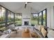 Bright sunroom featuring large windows, a cozy fireplace, and comfortable seating for year-round enjoyment at 2809 Theresa Eileen Way, Raleigh, NC 27603