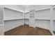 Walk-in closet with wood floors, built-in shelving and drawers for optimal storage at 2809 Theresa Eileen Way, Raleigh, NC 27603