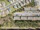 An aerial shot shows a community layout with townhomes, streets, parking, and green spaces at 30 Holly Berry Ln, Durham, NC 27703