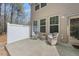 Outdoor patio featuring wicker chairs, a white privacy fence and natural light at 30 Holly Berry Ln, Durham, NC 27703