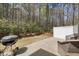 Outdoor patio and backyard featuring a privacy fence, wooded area, and a grill at 30 Holly Berry Ln, Durham, NC 27703