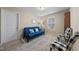 Bedroom showcasing neutral walls, a blue futon sofa, checkered chairs and a carpeted floor at 30 Holly Berry Ln, Durham, NC 27703