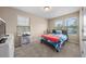 Cozy bedroom with two windows, carpeted floors, and a queen bed with colorful bedding at 30 Holly Berry Ln, Durham, NC 27703