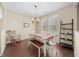 Cozy dining room featuring wood floors and a charming chandelier fixture at 30 Holly Berry Ln, Durham, NC 27703