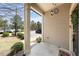 Welcoming front porch area with neutral siding and a charming outdoor light fixture at 30 Holly Berry Ln, Durham, NC 27703