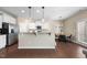 An open kitchen features white cabinets, granite countertops, stainless appliances, and a breakfast area at 30 Holly Berry Ln, Durham, NC 27703