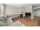 A well-lit living room has neutral paint, hardwood floors, a fireplace, and a large comfortable sofa at 30 Holly Berry Ln, Durham, NC 27703