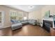 Bright living room features hardwood floors, fireplace, and a large window with outdoor views at 30 Holly Berry Ln, Durham, NC 27703