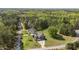 Aerial shot of a gray home on a large wooded lot with mature trees and lush green grass at 3034 E Bay Court, Creedmoor, NC 27522