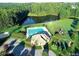 An aerial view showcases a backyard pool, a playground, and manicured landscaping at 3034 E Bay Court, Creedmoor, NC 27522