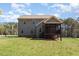 Expansive backyard highlighting the home's screened porch and tree-lined property at 3034 E Bay Court, Creedmoor, NC 27522