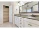 Bathroom with double sinks, granite countertops, framed mirror and a storage closet at 3034 E Bay Court, Creedmoor, NC 27522