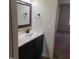Bathroom with a dark vanity, marble countertop and framed mirror at 3034 E Bay Court, Creedmoor, NC 27522
