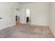 Bright bedroom featuring neutral walls, carpet, and white doors offering access to other rooms at 3034 E Bay Court, Creedmoor, NC 27522