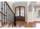 Elegant entryway featuring hardwood floors, staircase, and a striking front door with glass panels at 3034 E Bay Court, Creedmoor, NC 27522