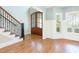 Inviting foyer with hardwood floors, staircase, and an impressive front door at 3034 E Bay Court, Creedmoor, NC 27522
