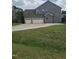 Beautiful home featuring an attached two-car garage and wide concrete drive situated on a lush green lot at 3034 E Bay Court, Creedmoor, NC 27522