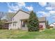 Landscaped yard featuring a cozy porch, mature trees, and green lawn, creating a picturesque and inviting outdoor space at 3034 E Bay Court, Creedmoor, NC 27522
