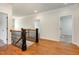 Upstairs hallway featuring wood floors and access to several rooms at 3034 E Bay Court, Creedmoor, NC 27522